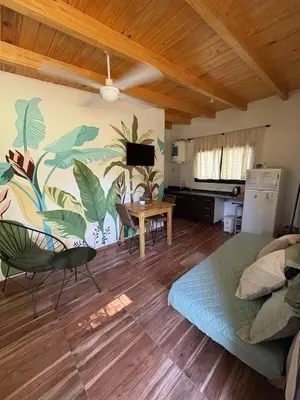a living room with a bed and a table at Ideal para parejas en Anisacate in Villa Anizacate
