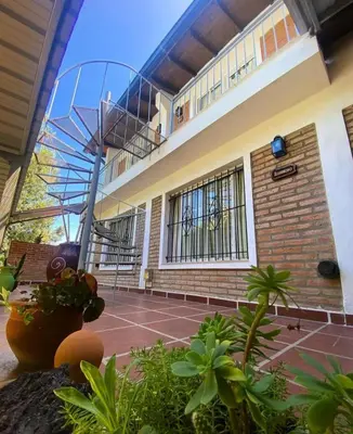 a view of a building with a tennis court at Calamuchita Apart Dos Talas in Santa Rosa de Calamuchita