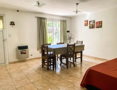 a dining room with a table and chairs in a room at Calamuchita Apart Dos Talas in Santa Rosa de Calamuchita