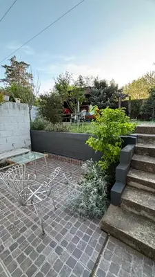 a house with a staircase and some plants and a building at Calamuchita Apart Dos Talas in Santa Rosa de Calamuchita