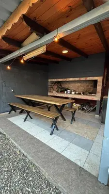 a ping pong table under awning on a patio at Calamuchita Apart Dos Talas in Santa Rosa de Calamuchita