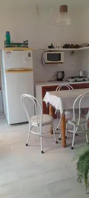 a kitchen with a table and chairs and a refrigerator at En lo de Ana in Villa Dolores