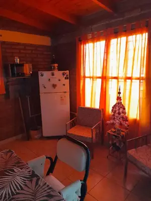 a living room with a refrigerator and a christmas tree at La Quinta de Juan in Villa Anizacate