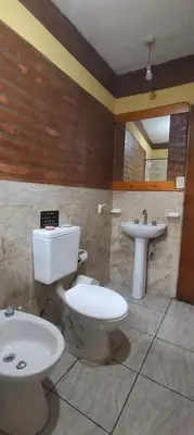 a bathroom with a toilet and a sink at La Quinta de Juan in Villa Anizacate