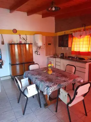 a kitchen with a table and chairs in a kitchen at La Quinta de Juan in Villa Anizacate