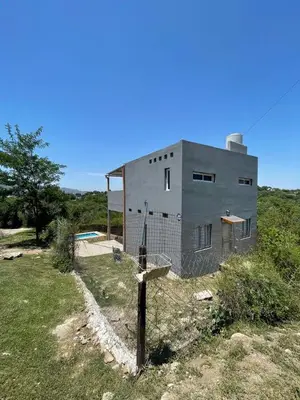 a building with a fence in front of it at La Casita de Caeiro in Bialet Massé