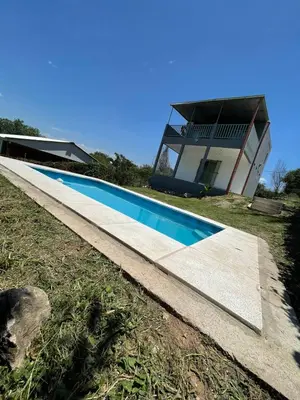 a swimming pool in front of a house at La Casita de Caeiro in Bialet Massé