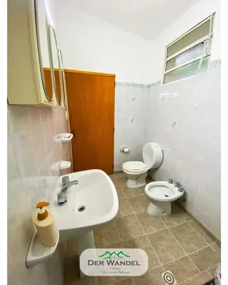 a bathroom with a sink and a toilet at Casa Der Wandel in Villa General Belgrano