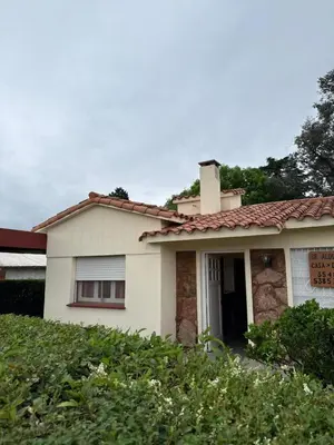 a house with a sign on the front of it at cabaña EL CHALECITO DE ANA in Villa del Dique