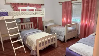 a bedroom with two bunk beds and twounks at cabaña EL CHALECITO DE ANA in Villa del Dique