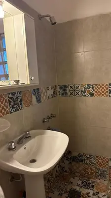 a bathroom with a sink and a mirror at cabaña EL CHALECITO DE ANA in Villa del Dique