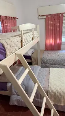 a room with two bunk beds and two beds at cabaña EL CHALECITO DE ANA in Villa del Dique