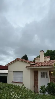 a white house with a chimney on top of it at cabaña EL CHALECITO DE ANA in Villa del Dique