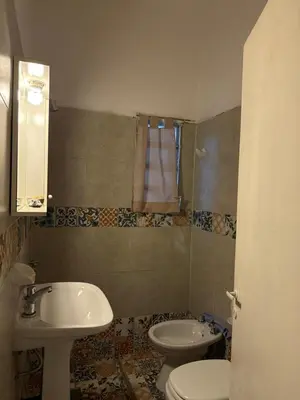 a bathroom with a sink and a toilet at cabaña EL CHALECITO DE ANA in Villa del Dique