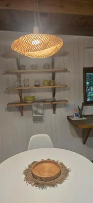 a room with a table and a light and shelves at MONTE CABAÑA San Clemente in San Clemente