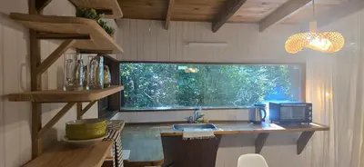 a kitchen with a counter with a sink and a window at MONTE CABAÑA San Clemente in San Clemente