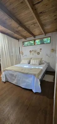 a bedroom with a large bed in a room at MONTE CABAÑA San Clemente in San Clemente