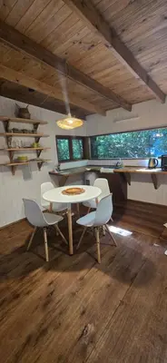 a dining room with a white table and chairs at MONTE CABAÑA San Clemente in San Clemente