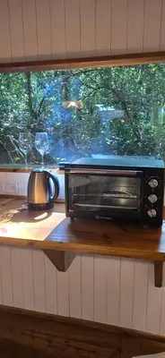 a toaster oven sitting on a counter next to a window at MONTE CABAÑA San Clemente in San Clemente