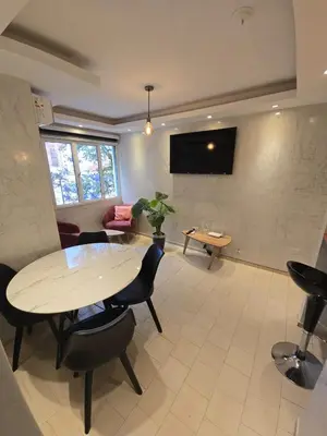 a living room with a table and chairs and a couch at Departamento en Bv San Juan a cuadras del shopping Patio Olmos in Cordoba