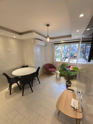 a living room with a table and chairs at Departamento en Bv San Juan a cuadras del shopping Patio Olmos in Cordoba