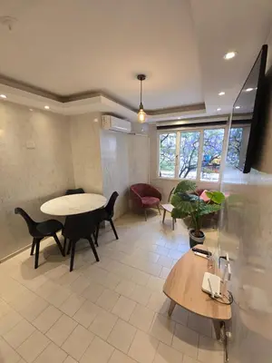 a living room with a table and chairs at Departamento en Bv San Juan a cuadras del shopping Patio Olmos in Cordoba