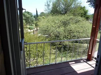 a balcony with a view of a bush at Finca - CASONA LAS MANSAS in Bialet Massé