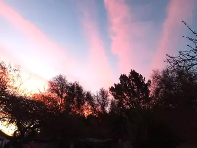 a colorful sky with trees in the foreground at Finca - CASONA LAS MANSAS in Bialet Massé