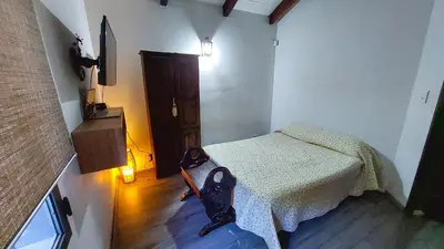 a small room with a bed in a room at Casa con pileta en Cabalango - Sierras de Córdoba IG alquilervillacarlospaz in Cavalango