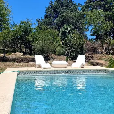 a swimming pool with two lounge chairs and a swimming pool at Casa con pileta en Cabalango - Sierras de Córdoba IG alquilervillacarlospaz in Cavalango