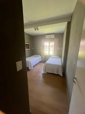 a room with two beds and a window at casa santa rita in Villa Carlos Paz