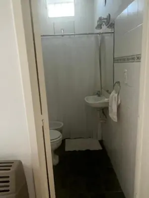 a small bathroom with a toilet and a sink at casa santa rita in Villa Carlos Paz