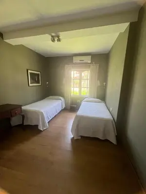 a room with two beds and a window at casa santa rita in Villa Carlos Paz