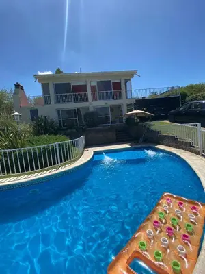 a swimming pool in front of a house at Elena in San Antonio de Arredondo