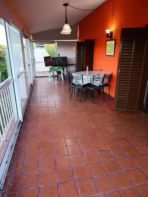 a patio with a table and chairs and a piano at Elena in San Antonio de Arredondo