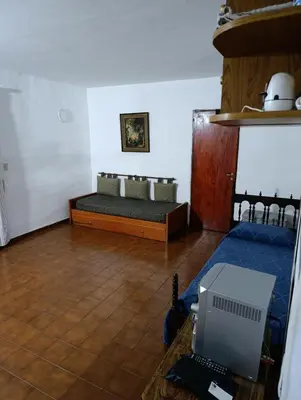 a room with a bed and a laptop on a table at Elena in San Antonio de Arredondo