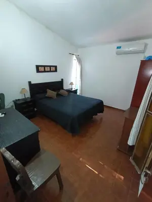 a bedroom with a bed and a table and a chair at Elena in San Antonio de Arredondo