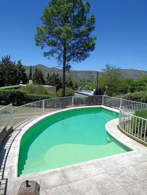 a swimming pool with a white fence around it at Elena in San Antonio de Arredondo