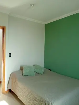 a bedroom with a bed with two pillows on it at Constantino Villa Carlos Paz departamento céntrico in Villa Carlos Paz