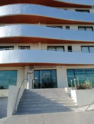a building with stairs in front of it at Constantino Villa Carlos Paz departamento céntrico in Villa Carlos Paz