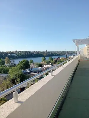 a balcony with a view of the water at Constantino Villa Carlos Paz departamento céntrico in Villa Carlos Paz