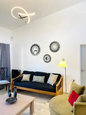 a living room with a blue couch and plates on the wall at La Casa del Mirador in Santa Rosa de Calamuchita