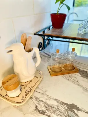 a white vase sitting on a plate on a counter at La Casa del Mirador in Santa Rosa de Calamuchita