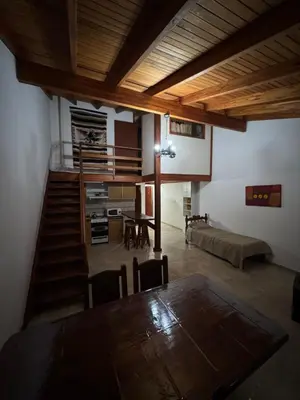 a living room with a table and a couch at Pepina Mina Clavero in Mina Clavero
