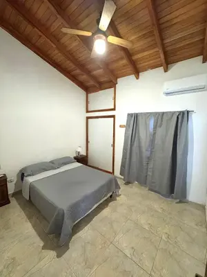 a bedroom with a bed and a ceiling fan at Pepina Mina Clavero in Mina Clavero