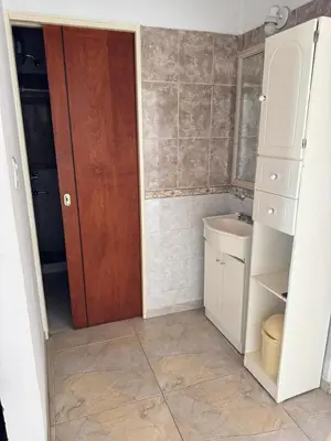 a small bathroom with a door and a sink at Pepina Mina Clavero in Mina Clavero
