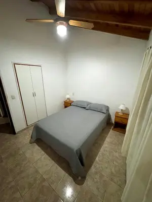 a bedroom with a large bed and two night stands at Pepina Mina Clavero in Mina Clavero