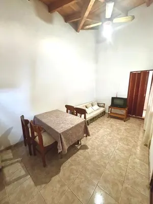 a room with a table and a couch and a tv at Pepina Mina Clavero in Mina Clavero