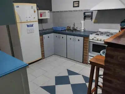 a kitchen with a white refrigerator and a stove at Azulina in Alta Gracia
