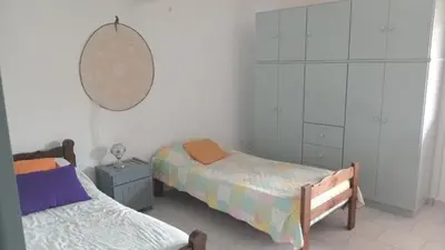 a bedroom with two beds and a mirror on the wall at Azulina in Alta Gracia